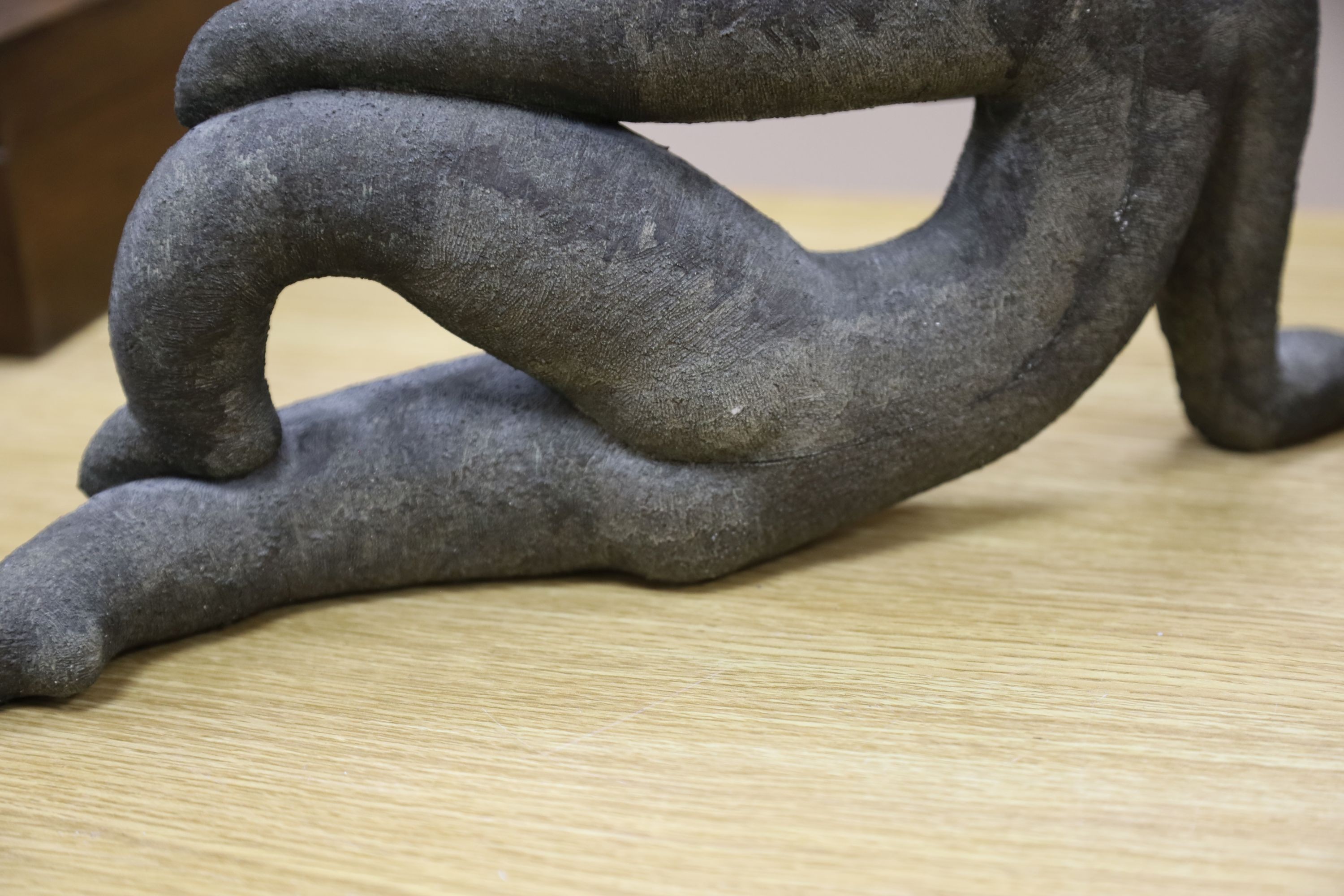 A bronzed pottery abstract figure, marked ‘WP 92’ 40cm
